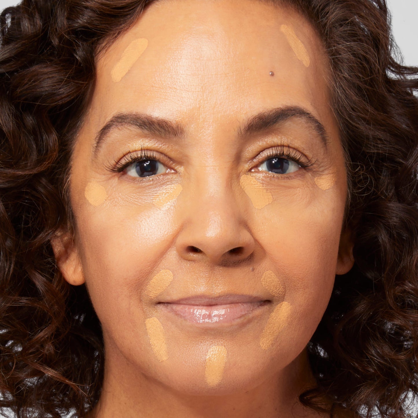 Cancel-n-Conceal Skin Perfector & Color Corrector model with product on face