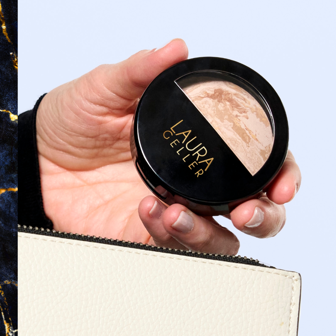 A hand holding a Baked Balance-n-Brighten Foundation compact