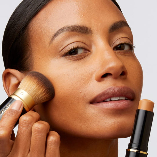 Women applying foundation with a brush