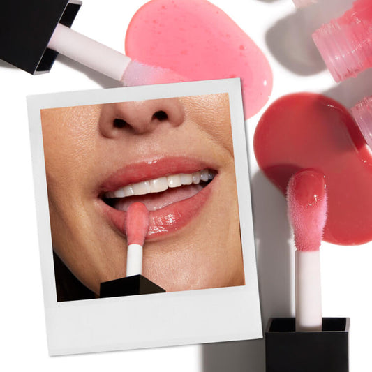Woman applying lip oil