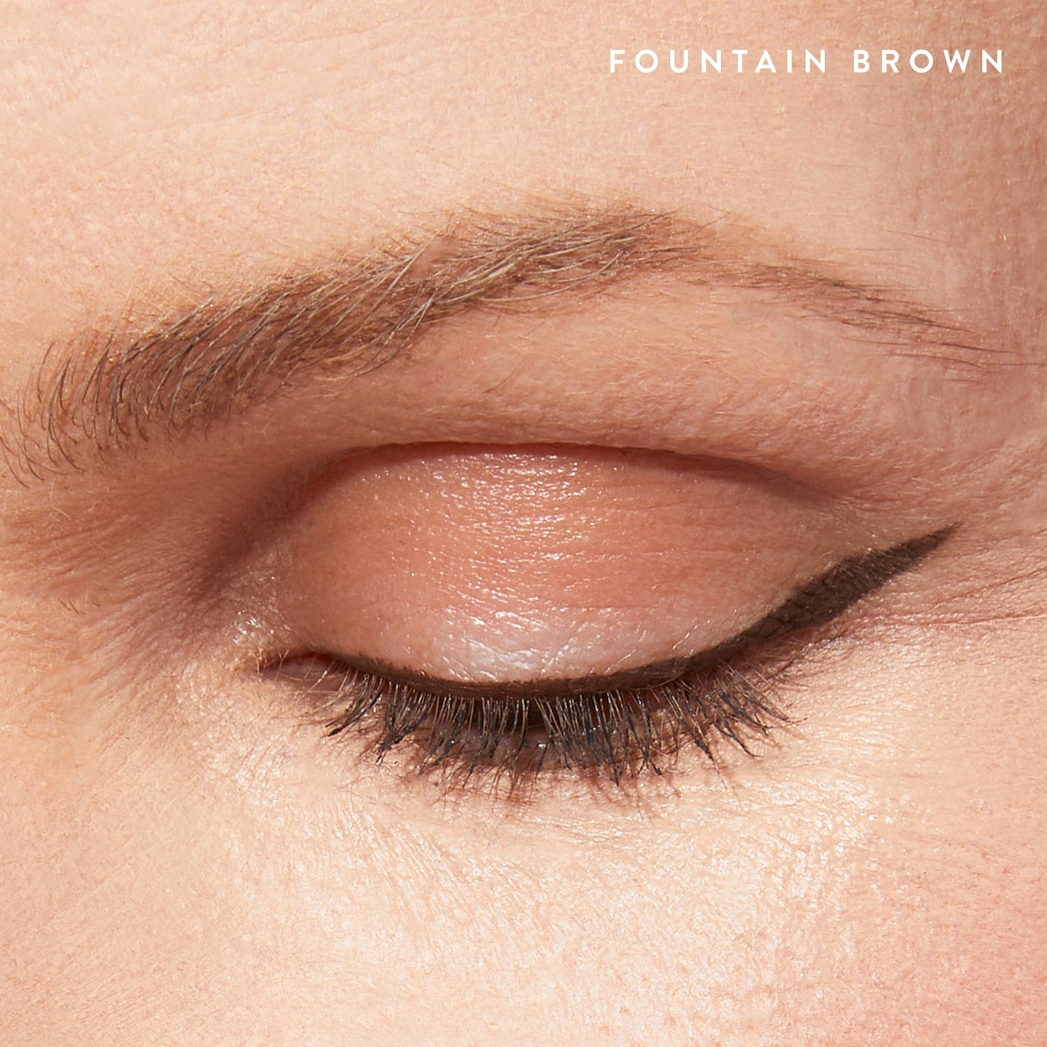Mighty Pen Liquid Eyeliner on model lifestyle wearing shade Fountain Brown