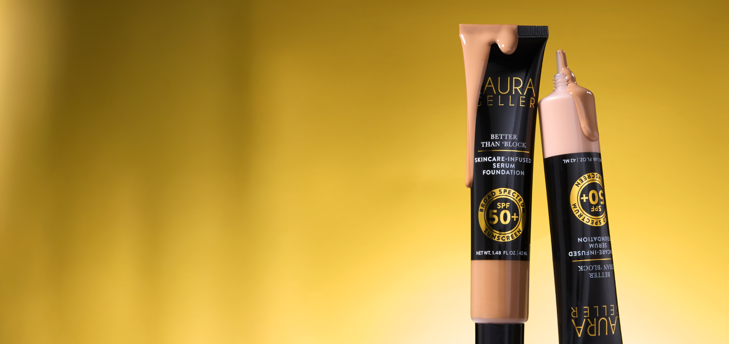 Two foundation product tubes with Laura Geller branding on a yellow background