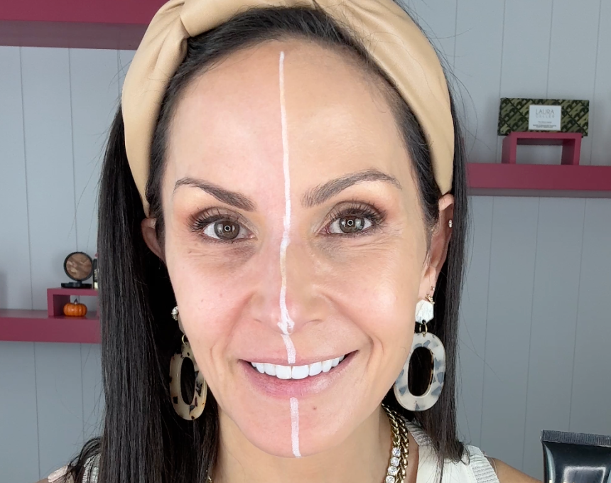 Woman with a white line drawn on her face to demonstrate the before and after effects of Laura Geller's Better Than Block.