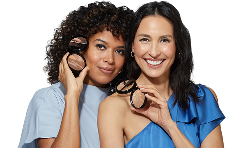 Two women holding makeup compacts for Try Before You Buy